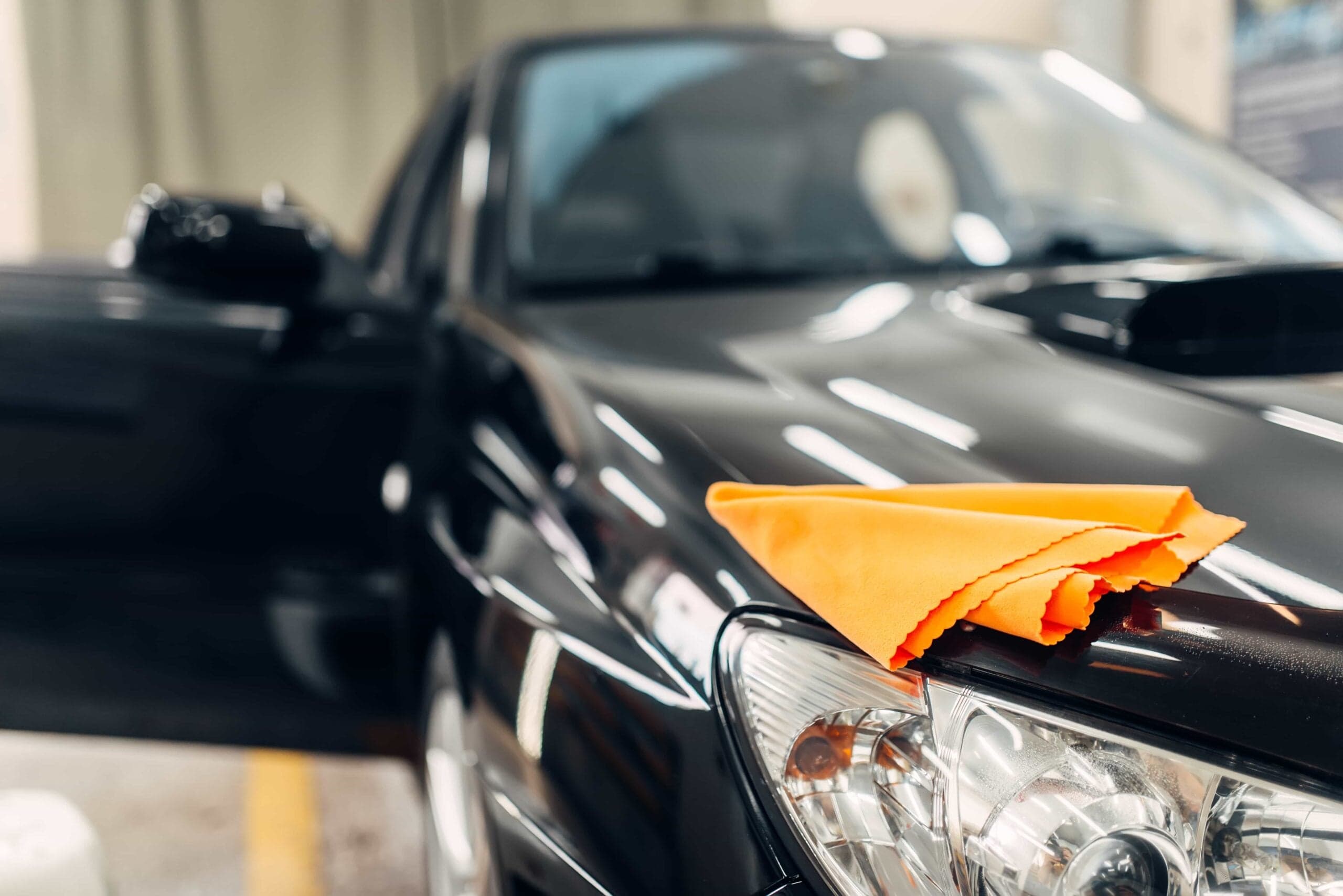 A microfiber cloth on the hood of a freshly cleaned car during professional detailing services in Ocala, FL.